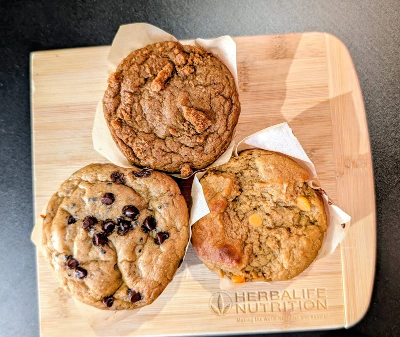 Three real muffins on a wooden InVibe serving board