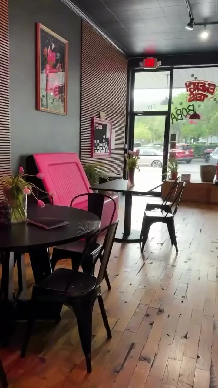 Pink seating and tables inside InVibe, photographed from the official club tour