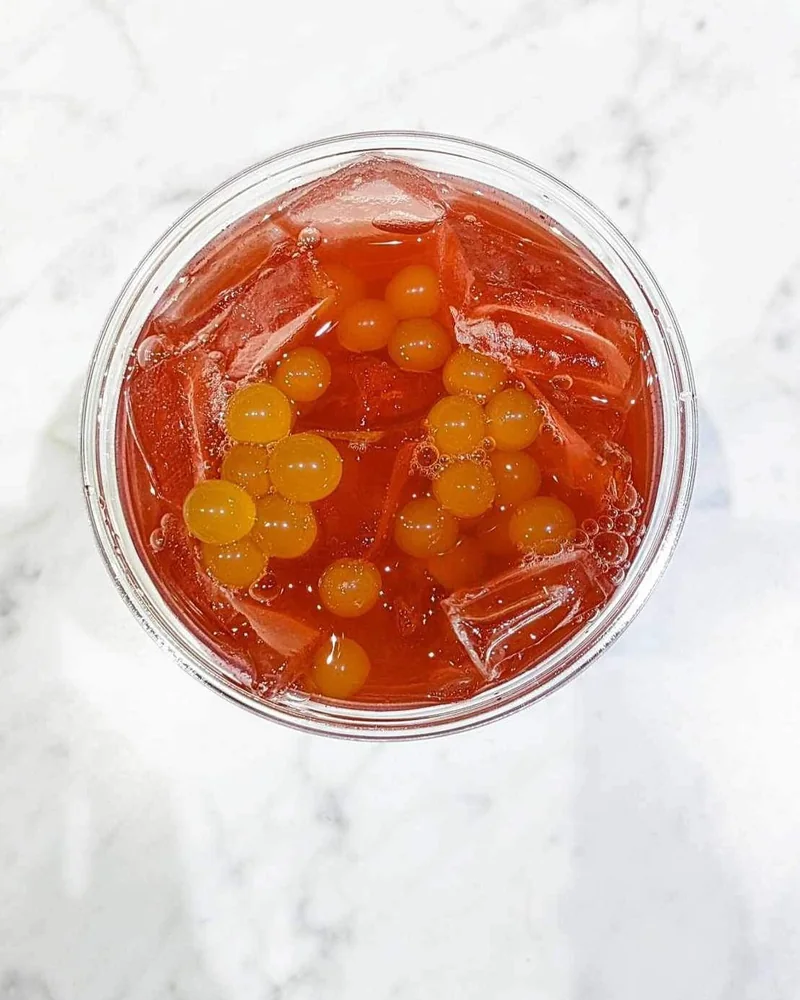An overhead view of an InVibe tea with colorful boba